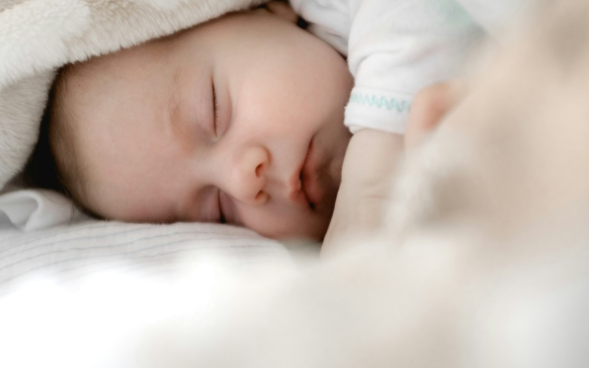 Newborn resting comfortably in serene nursery setting
